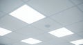 Bright Square Ceiling Lights in Hospital or Office with White Tiles and Speaker Seamless loop Perfect for Backgrounds Mockups and Royalty Free Stock Photo