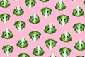 Seamless minimalistic pattern with broccoli on a pink background.