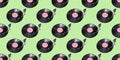 Seamless pattern. Abstract record player part isolated on green background. Retro music concept.