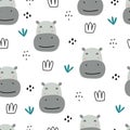 Seamless pattern animal cartoon background There`s a hippo`s face and a clump of grass. Hand-drawn in children style Royalty Free Stock Photo