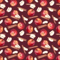 Seamless pattern with apples, slices and cinnamon sticks on maroon background. Royalty Free Stock Photo