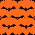 Seamless pattern with bats. Vector bats isolated on orange background. Silhouette of flying bat. Pattern for Hallowmas Royalty Free Stock Photo