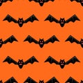 Seamless pattern with bats. Vector bats isolated on orange background. Silhouette of flying bat. Pattern for Hallowmas Royalty Free Stock Photo