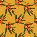 Seamless pattern with berries and branches of sea buckthorn. Sea buckthorn on a yellow background. Fashionable textile, fabric, pa