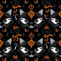Seamless pattern of black cats with orange decorative elements facing forward on a dark background creating a symmetrical artistic Royalty Free Stock Photo
