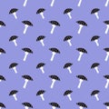 Seamless pattern with black fly agaric mushrooms with white dots on purple background. Royalty Free Stock Photo
