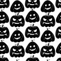 Seamless pattern with black silhouette of a pumpkin face for halloween on a white background Royalty Free Stock Photo