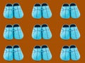 Seamless pattern of blue Slippers on a brown background. Royalty Free Stock Photo