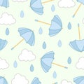 Seamless pattern of blue umbrellas, white clouds and drops, different shades of blue on a green background. Royalty Free Stock Photo