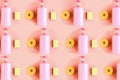 Seamless pattern of bottles with pink dishwashing liquid and sponges on pink pastel background. Minimal concept. Royalty Free Stock Photo