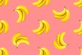 Seamless pattern from bundles of ripe yellow bananas on pink background. Tropical summer fruits concept Royalty Free Stock Photo