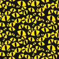 Seamless pattern with cat's yellow eyes on a black background. Bright glowing eyes of cats in the dark. Vector Royalty Free Stock Photo