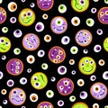 Seamless pattern of cheerful bright colorful monsters with big eyes and teeth on a black background. For Halloween, Kids Royalty Free Stock Photo