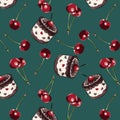 Color seamless pattern of cherries and muffins on a turquoise background.