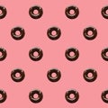 Seamless Pattern Of Chocolate Donuts On Pastel Pink Background Royalty Free Stock Photo
