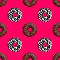 Seamless pattern chocolate and white donuts on bright pink background isolated top view, colorful donut repeating ornament on red Royalty Free Stock Photo