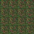 Seamless pattern with Christmas candy canes on a green background, top view Royalty Free Stock Photo