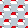 Seamless pattern with Christmas hats on gray. Red Santa cap. Background for festive designs, textile print, wrapping Royalty Free Stock Photo