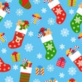 Seamless pattern Christmas socks with gifts on a blue background Royalty Free Stock Photo