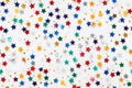 Seamless pattern of colored stars confetti on white background. Flat lay, top view Royalty Free Stock Photo