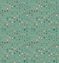 Seamless pattern. It consists of geometric elements having round shape, different size and color. On green background.