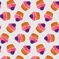 Seamless pattern with a cupcake with blueberries and with pink cream. On a cream background. Muffin. Sweet pastries decorated with