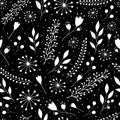 Seamless pattern with cute flowers and sprigs on a black background Royalty Free Stock Photo