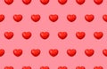 Seamless pattern of 3D red glossy hearts on a pink background for Valentine\'s Day. Royalty Free Stock Photo