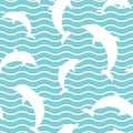 Seamless pattern with dolphins and waves on powder blue background Royalty Free Stock Photo