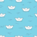 Seamless pattern with doodle paper boats on blue