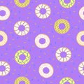 Seamless pattern of doughnuts with colored icing. Trendy beautiful donuts Purple background Royalty Free Stock Photo
