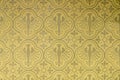 Seamless pattern of eagles and shapes of leafs in a wallpaper in gold yelloow and olive