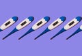 Seamless pattern of electronic thermometers with a normal human body temperature of 36.6 on a blue background
