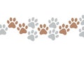 A seamless pattern featuring alternating brown and gray paw Royalty Free Stock Photo