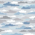 Seamless pattern featuring various stylized clouds in shades of blue, white, and gray. Royalty Free Stock Photo