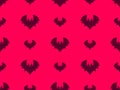 Seamless pattern with flying bats for Halloween decor. Bat silhouettes on a bright red background. A scary background with bats Royalty Free Stock Photo