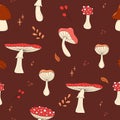 Seamless pattern with forest mushrooms. Red mushrooms with white dots on brown background. Amanita Muscaria ornament. fly agaric, Royalty Free Stock Photo