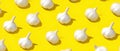 Seamless pattern of fresh garlic bulbs on yellow background Royalty Free Stock Photo