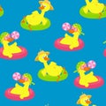 Seamless pattern of funny ducks swimming in the water on the rings for the pool. The ducks are dressed in a hat. Royalty Free Stock Photo
