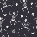 Seamless pattern with funny Halloween skeletons in different poses. Royalty Free Stock Photo
