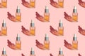 Seamless pattern of glass bottle with organic natural seed oil extract cosmetics for skin and hair care on pastel pink