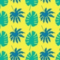 Vector seamless pattern background with green and blue tropical leaves on neon yellow background Royalty Free Stock Photo