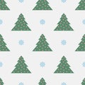 The seamless pattern with the green Christmas trees and the blue snowflakes is on the silver background Royalty Free Stock Photo