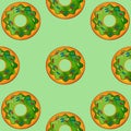 Seamless pattern of green donuts on a light green background. Confectionery sweets top view.