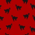 Seamless pattern Halloween black cats on red background, vector eps 10 Royalty Free Stock Photo