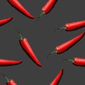 Seamless pattern with hand drawn red chili peppers illustration on dark grey background Royalty Free Stock Photo