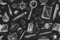 Seamless pattern of hand-drawn school supplies and space-themed objects on a chalkboard-style background, featuring Royalty Free Stock Photo