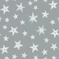 Seamless pattern of hand-drawn stylized stars decorates soft grey background. Various sized star shapes with white, light blue, Royalty Free Stock Photo