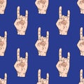 Seamless pattern with hands showing cool rock and roll signs. background for your design. illustration