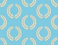 Seamless Pattern of Laurel Wreaths on a Blue Background Royalty Free Stock Photo